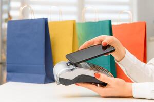 paying through smartphone using NFC technology. payment by phone through the terminal photo