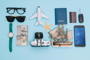 Travel accessories on blue background, travel concept. Top view with copy space photo