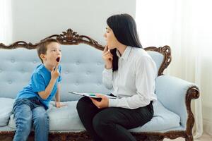 Picture of child psychologist working with young boy in office photo