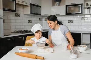 Happy family. Mother teaching her son how to cooking cake menu in morning. healthy lifestyle concept.. Baking Christmas cake and cook concept photo