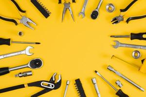 Set of various construction tools. Tools for home repair. Work at a construction site. On a yellow background. Flatly. Flatlay photo