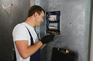 Portrait of an electrician at work photo