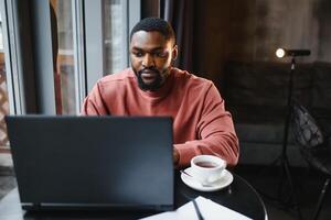 African american man working on laptop in a cafe. photo