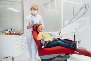 Female dentist and child in a dentist office photo