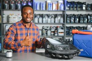 man holds automotive headlight in auto parts store photo