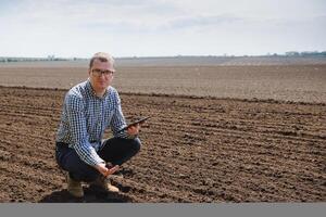 eco-activist at the landfill of used car tires calculates environmental damage. Nature conservation concept photo