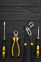 Set of hand tools . Equipment on wooden background. photo