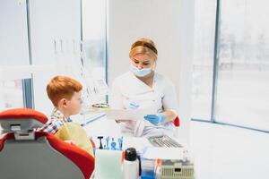 Female dentist and child in a dentist office photo