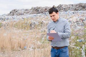 Environmental activist near the landfill. Keeping the environment clean. Ecological problems. Recycling photo