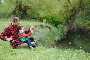 Dad and son fishing outdoors. father's day photo