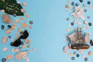 Flat lay. Top view. Frame of shells of various kinds on a blue background. Seashells and starfish and ship on a pastel background. Vacation concept. travel concept. with copy space photo