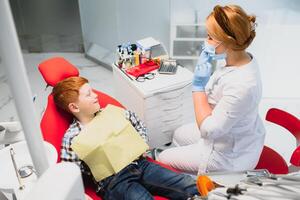 Female dentist and child in a dentist office photo