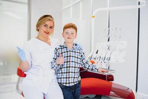 Female dentist and child in a dentist office photo