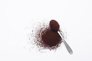 Scoop with ground coffee on white background photo
