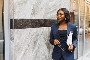 portrait of young african businesswoman standing outdoors photo