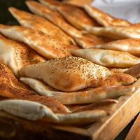 iraqi arabic bread served in dish side view on wooden table background photo