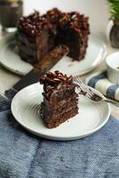 Chocolate Fudge Cake with fork and knife served in plate on food table top view cafe bake dessert photo