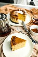 Salted Caramel Blondie cake slice include chocolate cream, sugar with fork, cup of coffee and pot served plate isolated on napkin side view of cafe food photo