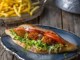 Falafel Sandwich served in dish side view on wooden table background photo