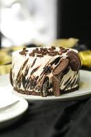 Oreo Cheesecake include chocolate, cream, sugar with fork and flowers served in plate isolated on napkin side view of cafe food photo