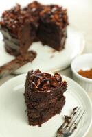Chocolate Fudge Cake with fork and knife served in plate on food table top view cafe bake dessert photo