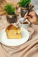Salted Caramel Blondie cake slice include chocolate cream, sugar with fork, cup of coffee and pot served plate isolated on napkin side view of cafe food photo