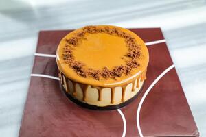 Salted Caramel Blondie cake include chocolate cream, sugar with fork, cup of coffee and pot served on board isolated on napkin side view of cafe food photo