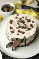 Oreo Cheesecake include chocolate, cream, sugar with fork and flowers served in plate isolated on napkin side view of cafe food photo