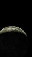 moon's illuminated surface in view from orbit, vertical video