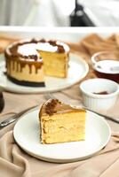 Salted Caramel Blondie cake slice include chocolate cream, sugar with fork, cup of coffee and pot served plate isolated on napkin side view of cafe food photo