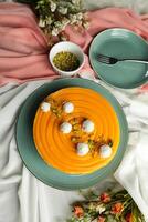 Mango Yogurt Cake topping with pistachio fork and flowers served in plate isolated on napkin top view cafe bake food photo