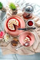 Premium Red Velvet cake and slice include cream, sugar with fork, cup of coffee and pot served on board isolated on napkin top view of cafe food photo