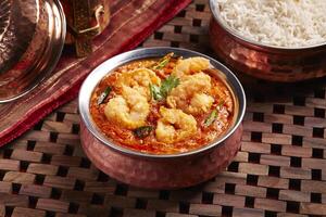 Spicy Prawns Masala served in dish isolated on table side view of middle east food photo