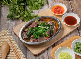 Fried Duck Blood with chilli sauce, noodles, spoon and chopsticks served in dish isolated on napkin top view of hong kong food photo