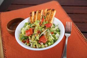 Spicy Salad With Grill Chicken, tomato, cucumber and cabbage served in a dish isolated on table side view of middle east food photo