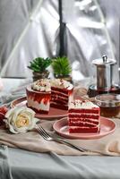 Premium Red Velvet cake and slice include cream, sugar with fork, cup of coffee and pot served on board isolated on napkin side view of cafe food photo