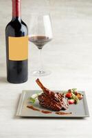 Baked Lamb Rack in Red Wine Reduction served in a dish isolated on grey background photo