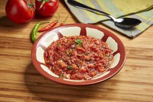 Spicy Salad paste served in dish isolated on table side view of middle east food photo