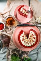 Premium Red Velvet cake and slice include cream, sugar with fork, cup of coffee and pot served on board isolated on napkin top view of cafe food photo