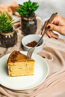 Salted Caramel Blondie cake slice include chocolate cream, sugar with fork, cup of coffee and pot served plate isolated on napkin side view of cafe food photo