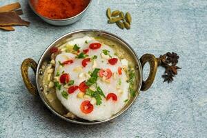 Kashmiri Chicken karahi with onion and chili served in a dish isolated on grey background top view of bangladesh food photo