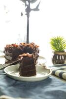 Chocolate Fudge Cake with fork and knife served in plate on food table top view cafe bake dessert photo