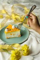 Mango Yogurt Cake slice topping with pistachio fork and flowers served in plate isolated on napkin side view cafe bake food photo