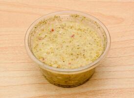 Raita or green chutney served in dish isolated on table top view indian spicy food photo