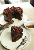 Chocolate Fudge Cake with fork and knife served in plate on food table top view cafe bake dessert photo