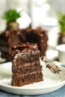 Chocolate Fudge Cake with fork and knife served in plate on food table top view cafe bake dessert photo
