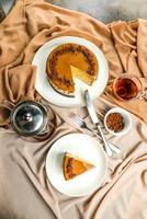 Salted Caramel Blondie cake slice include chocolate cream, sugar with fork, cup of coffee and pot served plate isolated on napkin top view of cafe food photo