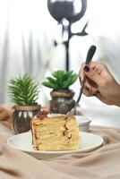 Salted Caramel Blondie cake slice include chocolate cream, sugar with fork, cup of coffee and pot served plate isolated on napkin side view of cafe food photo
