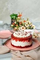 Premium Red Velvet cake include cream, sugar with fork, knife and flowers served in plate isolated on napkin side view of cafe food photo