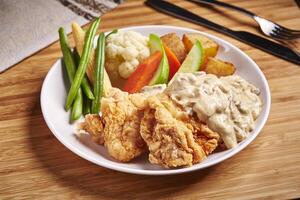 chicken Fillet Cream Sauce with cucumber and potato served in dish isolated on table side view of middle east food photo